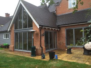 Removed brickwork and installed bespoke colour bi-folding doors and matching apex frame