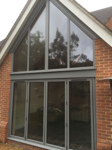 Removed brickwork and installed bespoke colour bi-folding doors and matching apex frame